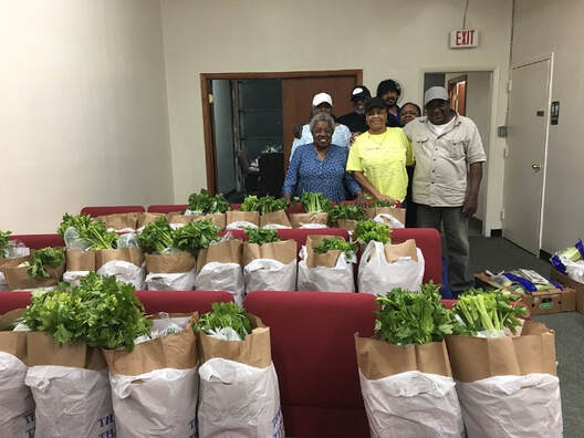 pastor and friends with food bags